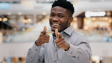 Close-up Happy Young Handsome African American Man Looking At Camera Smiling Posing Showing Gesture Hey You Pistols Making Choice Approval Sign Consent Symbol Pointing Fingers Demonstrates Support
