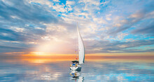 Lonely Yacht Sailing In The Mediterranean Sea At Amazing Sunset - Sailing Luxury Yacht With White Sails In The Sea.
