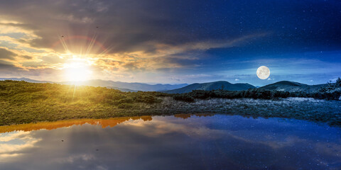 Wall Mural - day and night time change concept above landscape with lake in summer. peaceful reflection in the wa