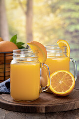 Wall Mural - Two glasses of orange juice with orange slices