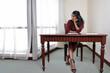 © oqba - Indian woman in modern skirt dress working reading study research at home office table chair bright window background