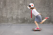 © Sunny studio - Funny businesswoman riding skateboard outdoor