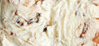 Surface of tiramisu ice cream. Texture of white ice cream with layers of chocolate or coffee.