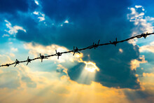 Barbed Wire Fence With Silhouette Sky And Cloud