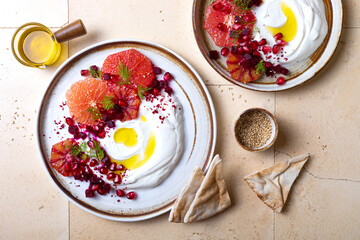 Labneh middle eastern lebanese cream cheese dip. Labneh with grapefruit,  roasted beetroot, pomegranate, fennel, sumac.