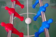 Close up of foosball Table Soccer Game match figures. Football Kicker Game with blue and red figurines.