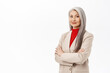 Portrait of professional asian senior businesswoman, cross arms on chest, looking confident, wearing stylish suit, smiling assertive, working in corporate, white background