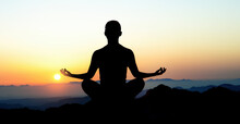 Silhouette Of Man In Yoga Lotus Pose On Top Of Mountain. Meditation And Astrology. Esoterica And Psychology. Landscape In Sunrise. Elements Of This Image Furnished By NASA