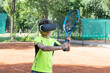 © Anna - Close up image of boy in vr glasse on tennis court with raquet in his hands. Training process in cyberspace with virtual coach.
