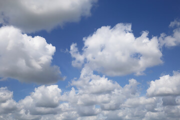 isolated blue summer sky cloudscape photo with white fluffy fair weather cumulus clouds