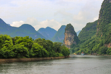 landscape photography of the li river in the guilin region of china with mountains in the background