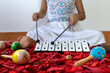 © Amilciar - Latin American girl playing a xylophone in her music class.