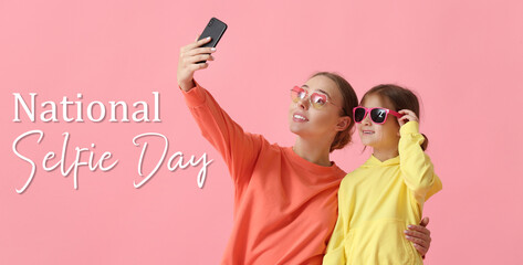 Sticker - Young woman and her little daughter taking selfie on pink background