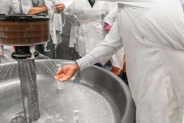 Unrecognizable workers washing their hands at a food production plant in Chinandega Nicaragua