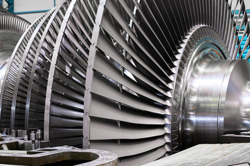 rotor with blades of powerful steam turbine in workshop