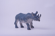 Miniature Realistic Rhino Figurine Isolate On A Studio Lighting Shot. Animal Toys For Kids