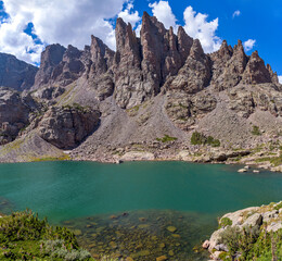 Wall Mural - Sky Pond and Sharkstooth - A sunny Summer day view of clear and colorful Sky Pond, with rugged pinnacles of Sharkstooth towering at shore. Rocky Mountain National Park, Colorado, USA.