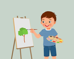 Poster - cute little boy artist holding color palette and paintbrush painting on the canvas 