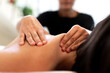 Close up of female hands giving back massage to woman. Selective focus.