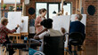 © DC Studio - Young woman with disability learning to draw sketch on canvas, attending art class lesson with teacher for personal growth. Person in wheelchair drawing vase model to develop new skills.