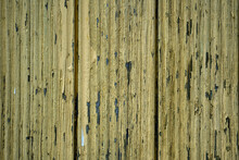 Old Cracked Yellow Paint On A Wooden Wall. Abstract Background. Texture Of An Old Grungy Board
