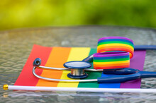Stethoscope And Rainbow Lgbt Wristband On Lgbt Flags, Concept For Medical Support Lgbtq Pride Month, Lgbtq Equality Community  Movement
