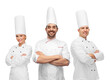 © Syda Productions - cooking, culinary and profession concept - team of smiling chefs with crossed arms