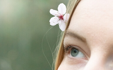 Woman wearing a cherry blossom flower in hair