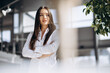 © Petro - Portrait of business woman in white shirt standing in office