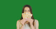 © Oleksii - young woman raises money to her face, covering the lower part of it. Rejoices in cash euro, smiles. The concept of microcredit, winning the lottery, salary.