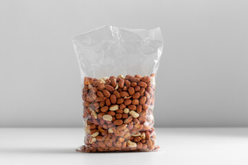 Wall Mural - food, healthy eating and diet concept - bag with raw peanuts on white background