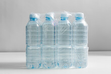 Recycling, Packing And Storage Concept - Close Up Of Plastic Bottles With Pure Drinking Water On Table