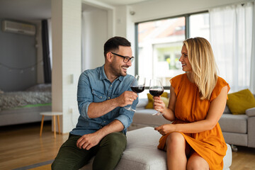 Wall Mural - Happy couple having a romantic date and drinking wine. Couple love romance concept.