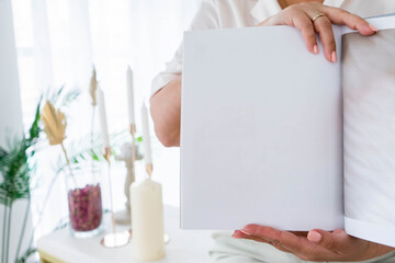 white book mockup square empty book album with clean pages in hands of woman clean book cover mock u