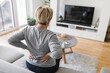 © and.one - Elderly woman at home with back pain
