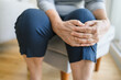 Senior woman holding her painful knee