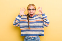 Young Adult  Blonde Woman Screaming In Panic Or Anger, Shocked, Terrified Or Furious, With Hands Next To Head