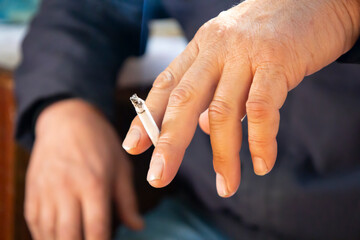 Close up young man smoking a cigarette.