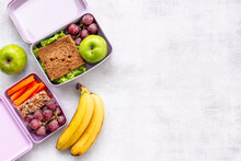 Student Meal In Purple Lunch Boxes, Top View. Healthy Shacks