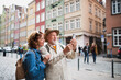 © Halfpoint - Portrait of happy senior couple tourists doing selfie outdoors in historic town