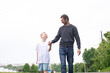 © Julia Jones - A father walks with his son on the road. The child is indulging
