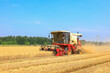 © zhengzaishanchu - combine harvester working on a wheat field