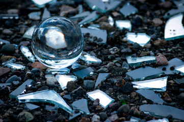 Wall Mural - Pieces of broken mirror and a lens ball on the ground.