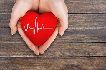 Wall Mural - World Hypertension Day. Adult holds a red heart with a heartbeat chart, a symbol of high blood pressure.