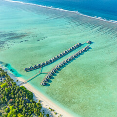 Wall Mural - Maldives. Tropical beach and water bungalows. Travel and tourism to luxury resorts in the Maldives islands. Summer holiday concept