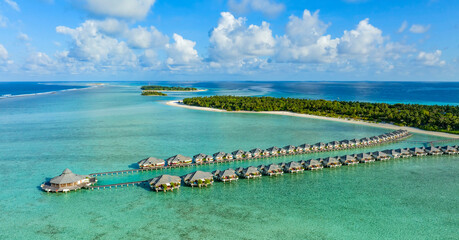 Wall Mural - Tropical beach and water bungalows. Travel and tourism to luxury resorts in the Maldives islands. Summer holiday concept Maldive