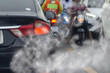 Smoke pollution from car exhaust pipes, traffic jams on the roads at rush hour.