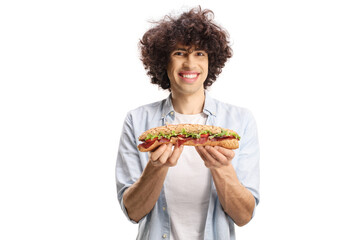 Poster - Young man with curly hair holding a baguette sandwich and smiling