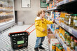 © Svetlana Repnitskaya - child in the market with a grocery cart, chooses a product