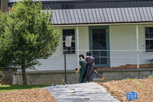 Two Amish Girls Working In The Garden At Their Homestead | Holmes County, Ohio